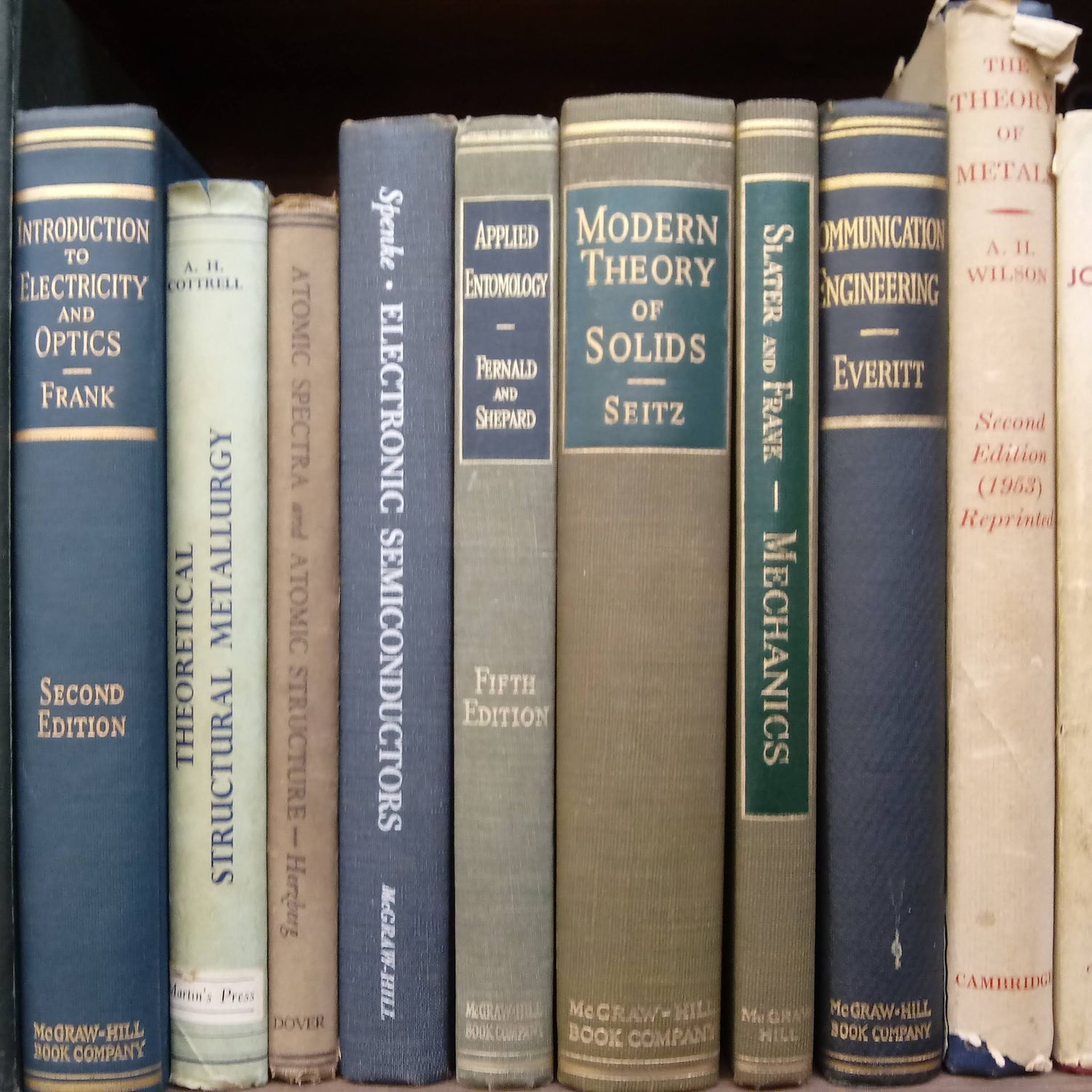 Vintage mechanical engineering and physics books on a shelf